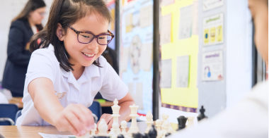 Primary aged student playing chess.