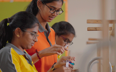 Three students inthe chemistry lab.