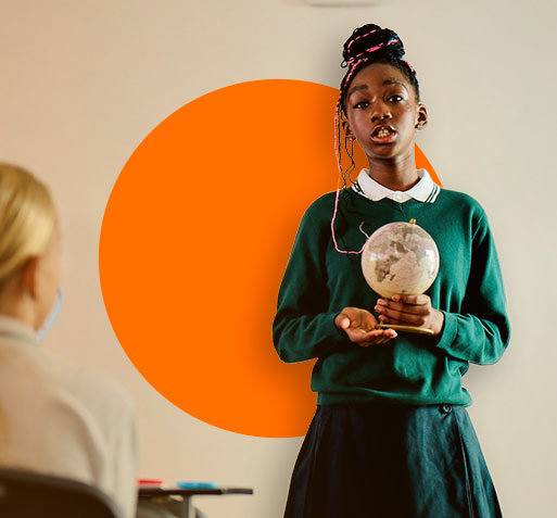 _DSC0574_2_pqrr3j 1 A young secondary girl standing in front of a class wearing her green school uniform and holding a small globe.