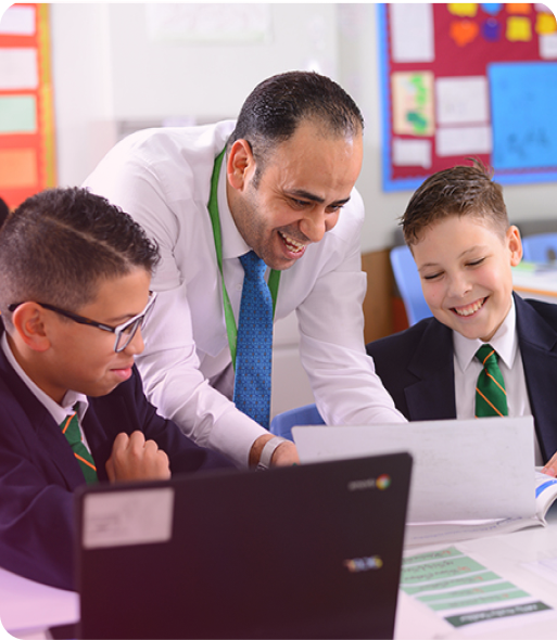 An early primary student excitedly points to a screen.